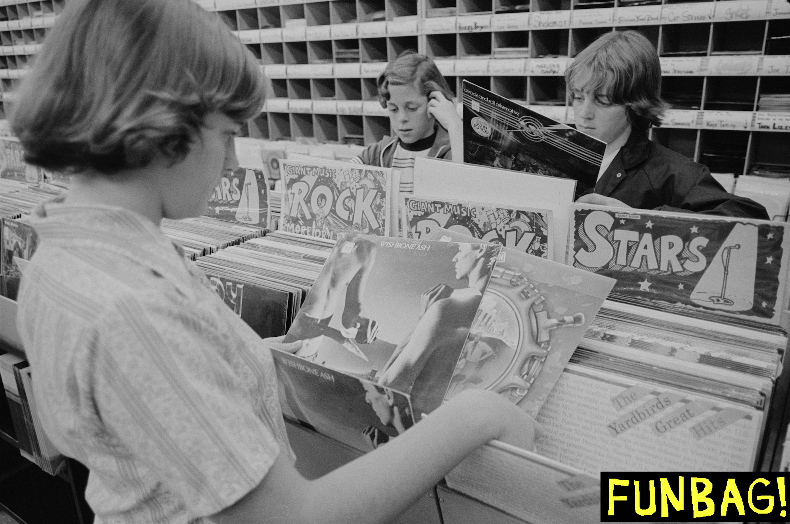 View of young music fans as they look at vinyl LPs in the racks of an unidentified record store, Falls Church, Virginia, October 13, 1977. The teen at fore holds two albums ('New England' and 'Locked In') by British rock group Wishbone Ash. (Photo by Warren K Leffler/US News & World Report Magazine Photograph Collection/PhotoQuest/Getty Images)