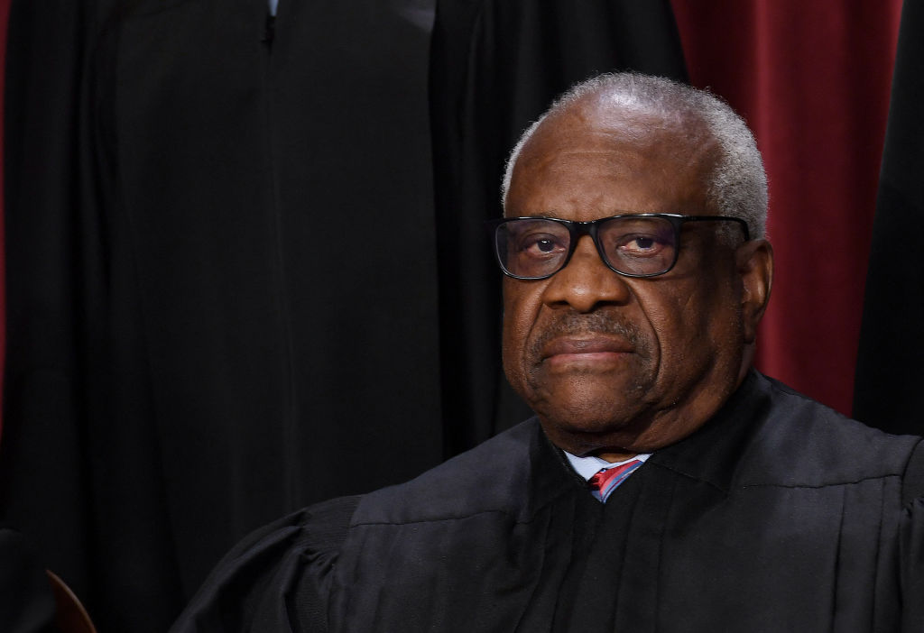 Associate US Supreme Court Justice Clarence Thomas poses for the official photo at the Supreme Court, dressed in black robes.