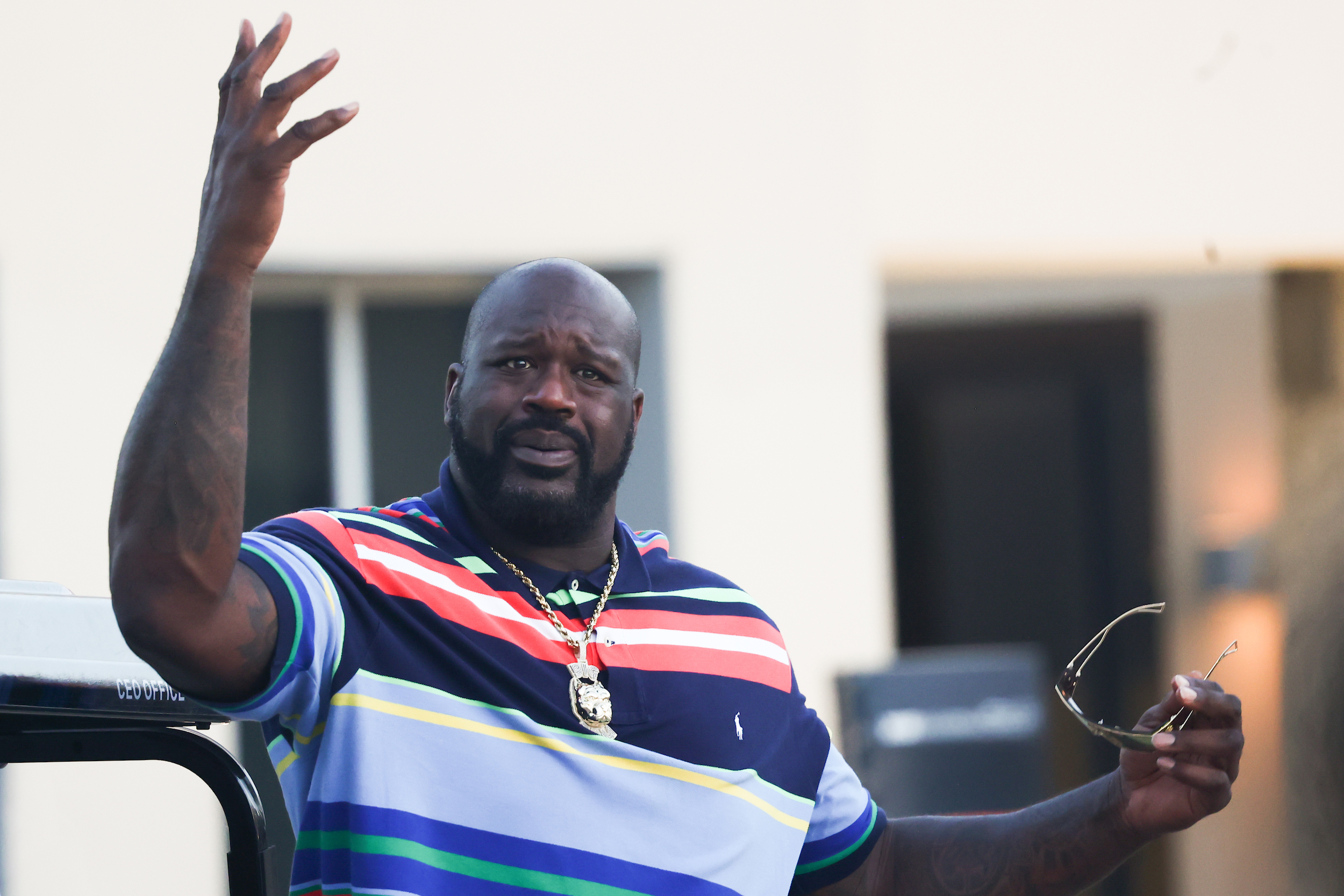 Shaq hams it up for photographers at a Formula 1 event.