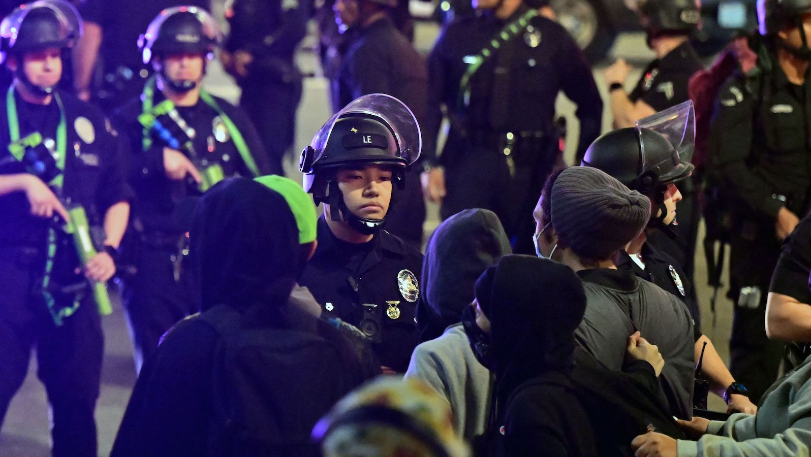 Protesters face off with a line of police officers during a rally against the fatal police assault of Tyre Nichols outside the LAPD headquarters, in Los Angeles, California, on January 27, 2023. - The US city of Memphis released January 27, 2023 graphic video footage depicting the fatal police assault of a 29-year-old Black man, as cities nationwide braced for a night of protests against police brutality. Five Memphis officers, also all Black, were charged with second-degree murder in the beating of Tyre Nichols, who died in hospital on January 10 three days after being stopped on suspicion of reckless driving. (Photo by Frederic J. Brown / AFP)