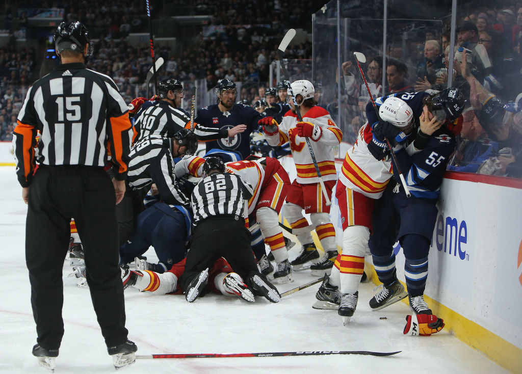 Mark Scheifele and Mikael Backlund fight as their teams scrum