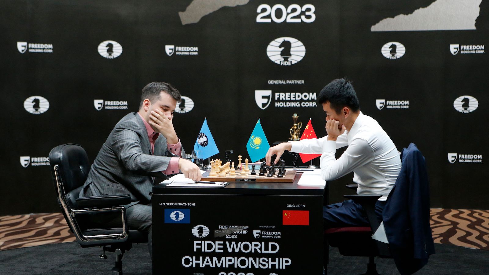 Grandmasters Ian Nepomniachtchi (L) from Russia and Ding Liren from China attend the first game of a 14-game match to decide who will be the new 17th World Chess Champion in Astana on April 9, 2023.