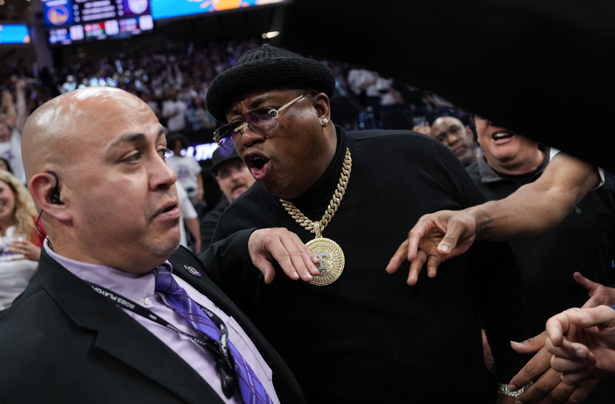 The rapper E-40 yells at arena security personnel before being escorted from courtside seating during Game One of the Western Conference First Round Playoffs between the Golden State Warriors and Sacramento Kings
