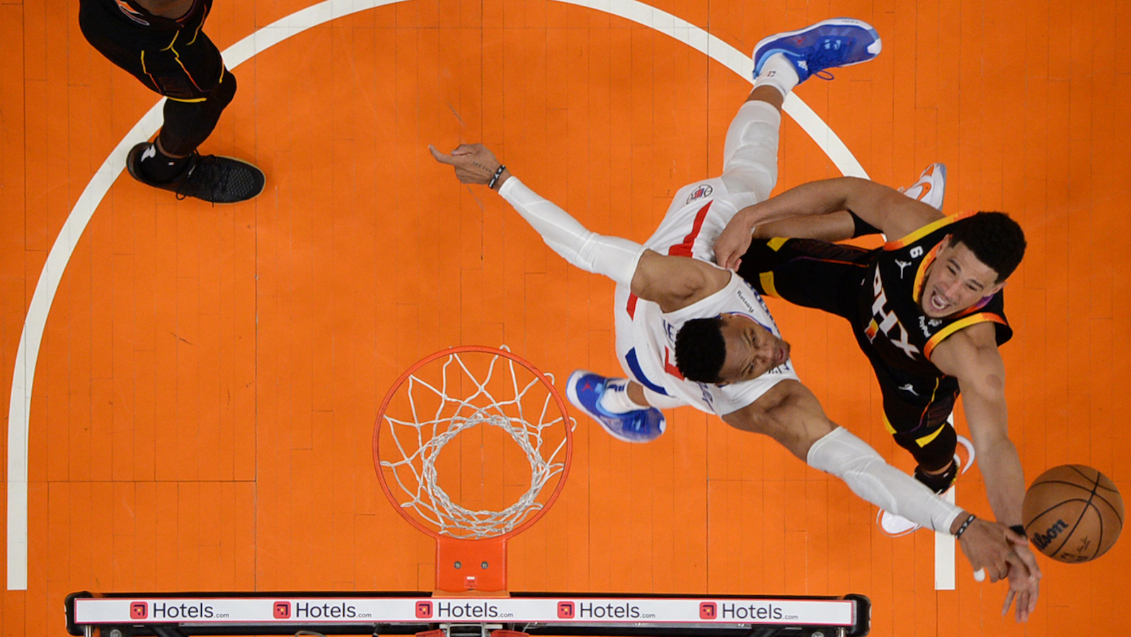 PHOENIX, AZ - APRIL 16: Russell Westbrook #0 of the LA Clippers blocks the shot by Devin Booker #1 of the Phoenix Suns, winning Round One Game One of the 2023 NBA Playoffs on April 16, 2023 at Footprint Center in Phoenix, Arizona. NOTE TO USER: User expressly acknowledges and agrees that, by downloading and or using this photograph, user is consenting to the terms and conditions of the Getty Images License Agreement. Mandatory Copyright Notice: Copyright 2023 NBAE