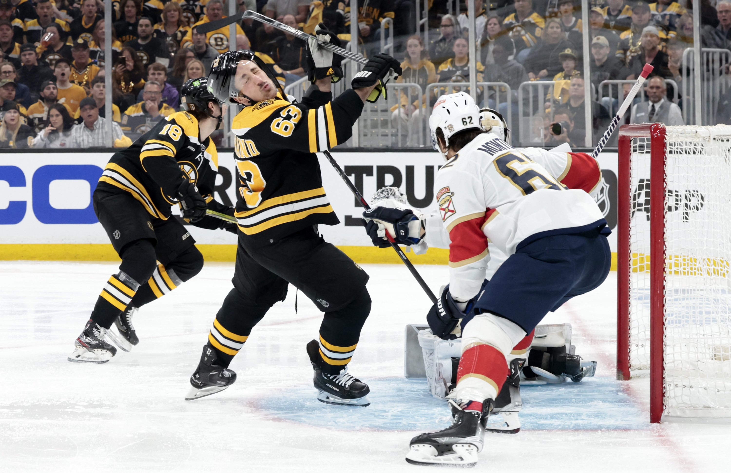 BOSTON, MA - APRIL 17: Boston Bruins left wing Brad Marchand (63) takes a high stick from Florida Panthers defenseman Brandon Montour (62) during Game 1 of an Eastern Conference First Round playoff contest between the Boston Bruins and the Florida Panthers on April 17, 2023, at TD Garden in Boston, Massachusetts. (Photo by Fred Kfoury III/Icon Sportswire via Getty Images)