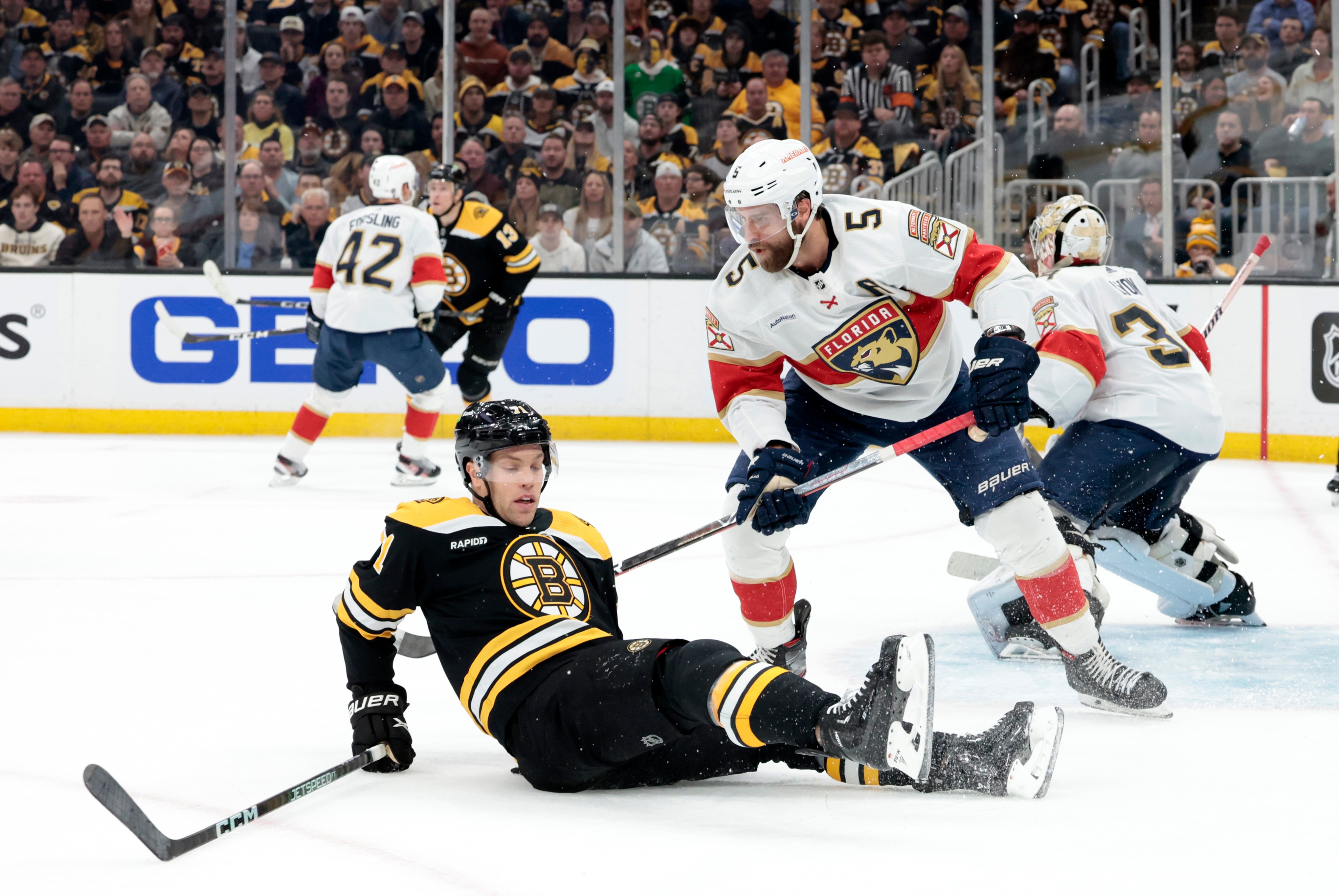 Florida Panthers defenseman Aaron Ekblad (5) dumps Boston Bruins left wing Taylor Hall (71) during Game 2 of an Eastern Conference First Round playoff contest between the Boston Bruins and the Florida Panthers on April 19, 2023, at TD Garden in Boston, Massachusetts.