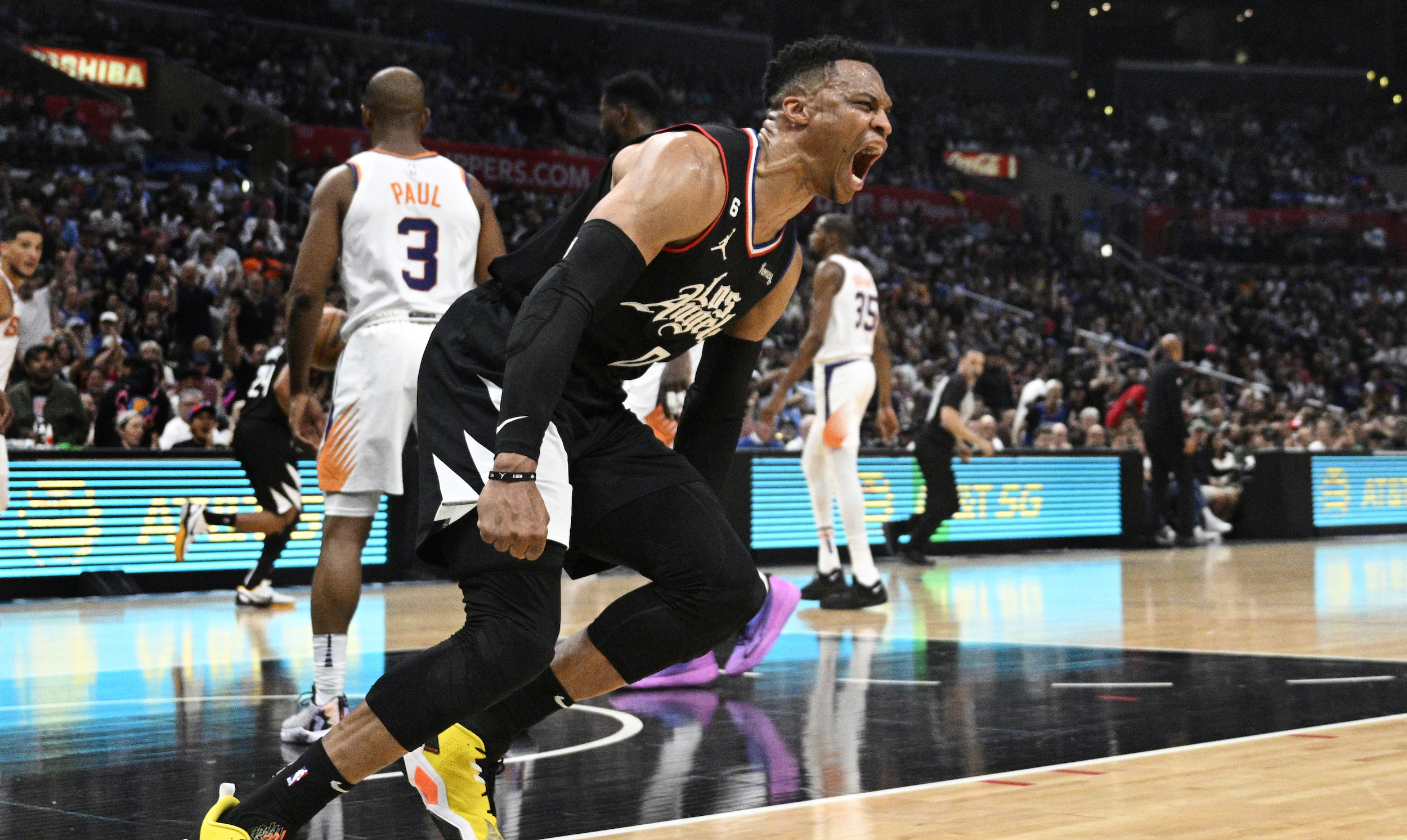 Russell Westbrook yells after dunking.