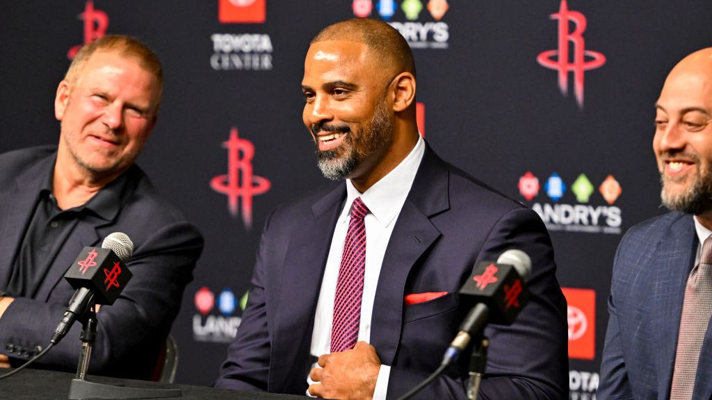 The Houston Rockets introduce Ice Udoka as the next head coach during a press conference on April 26, 2023 at the Toyota Center in Houston, Texas. All three men are sitting at a table. Udoka is in the center, with the team owner on the left and the team GM on the right.