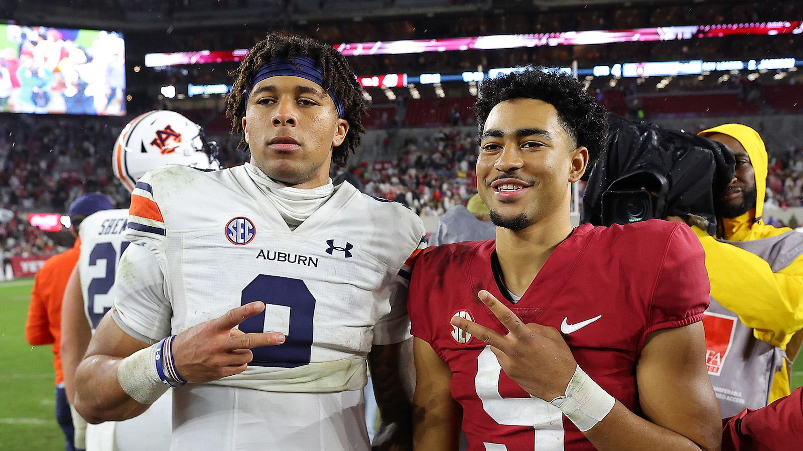 TUSCALOOSA, ALABAMA - NOVEMBER 26: Bryce Young #9 of the Alabama Crimson Tide and Robby Ashford #9 of the Auburn Tigers pose for a picture after the Crimson Tide's 49-27 win at Bryant-Denny Stadium on November 26, 2022 in Tuscaloosa, Alabama.