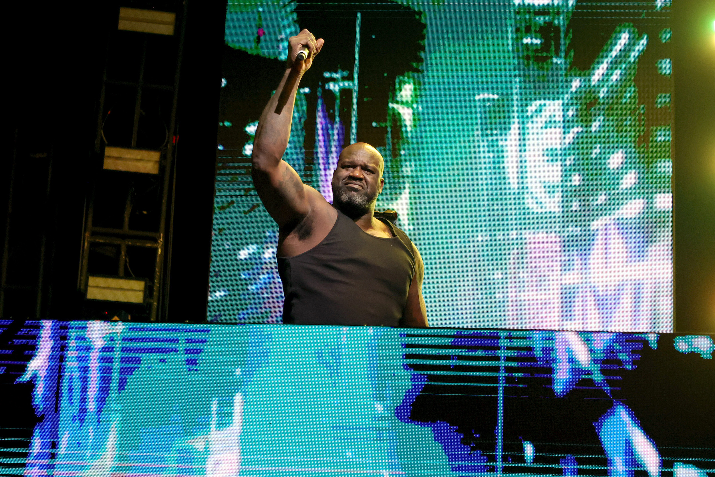 Shaquille O'Neal performs as a DJ at a party.