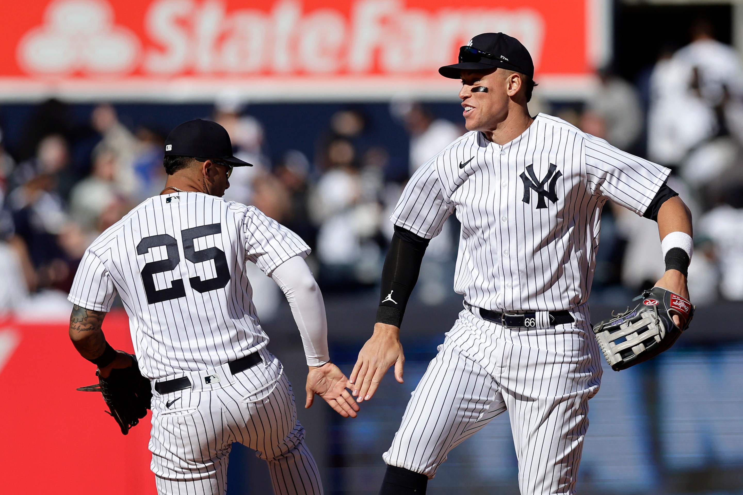 Aaron Judge and Gleyber Torres' high-fiving after a Yankees win on April 2, 2023.