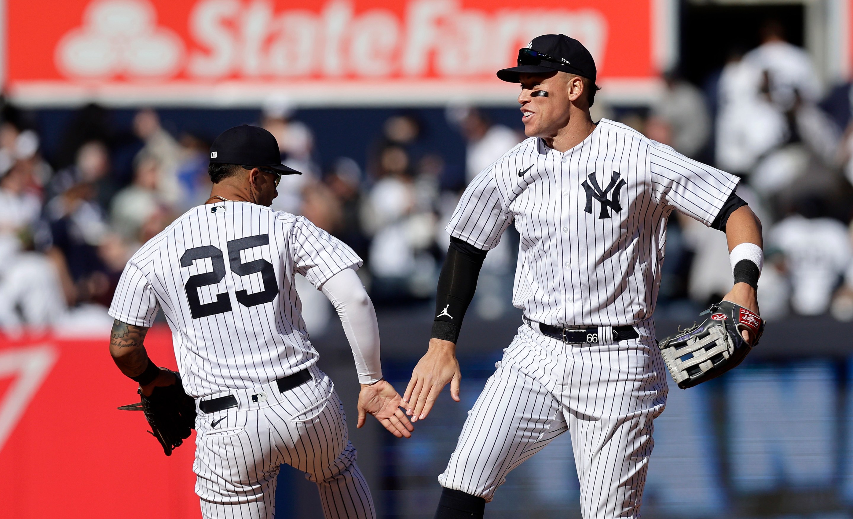 Aaron Judge and Gleyber Torres' high-fiving after a Yankees win on April 2, 2023.