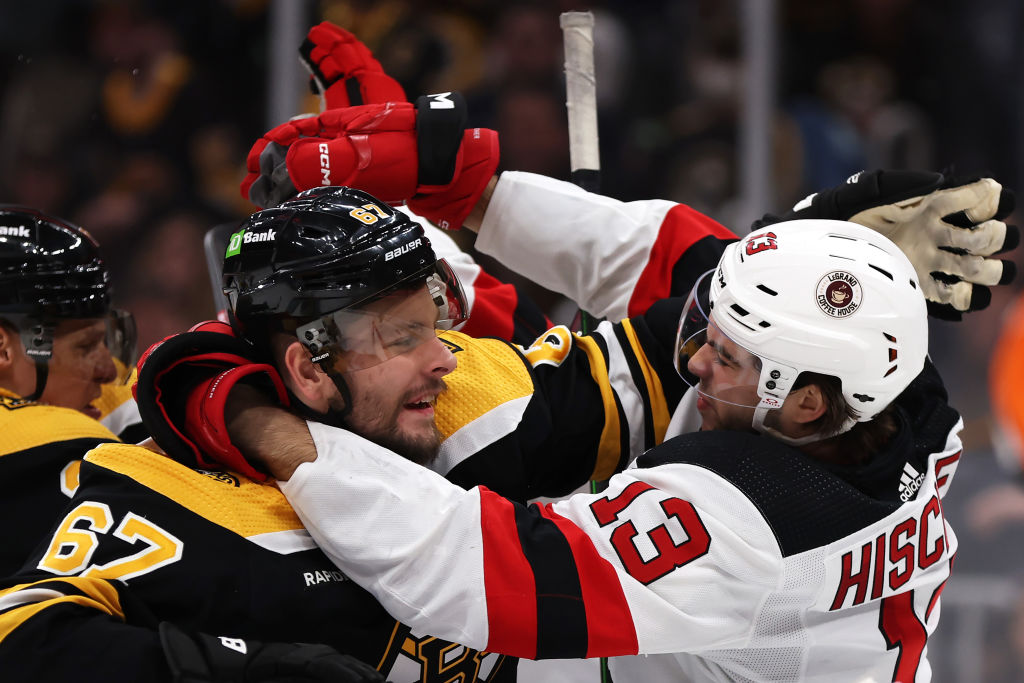 Nico Hischier #13 of the New Jersey Devils and Jakub Zboril #67 of the Boston Bruins fight