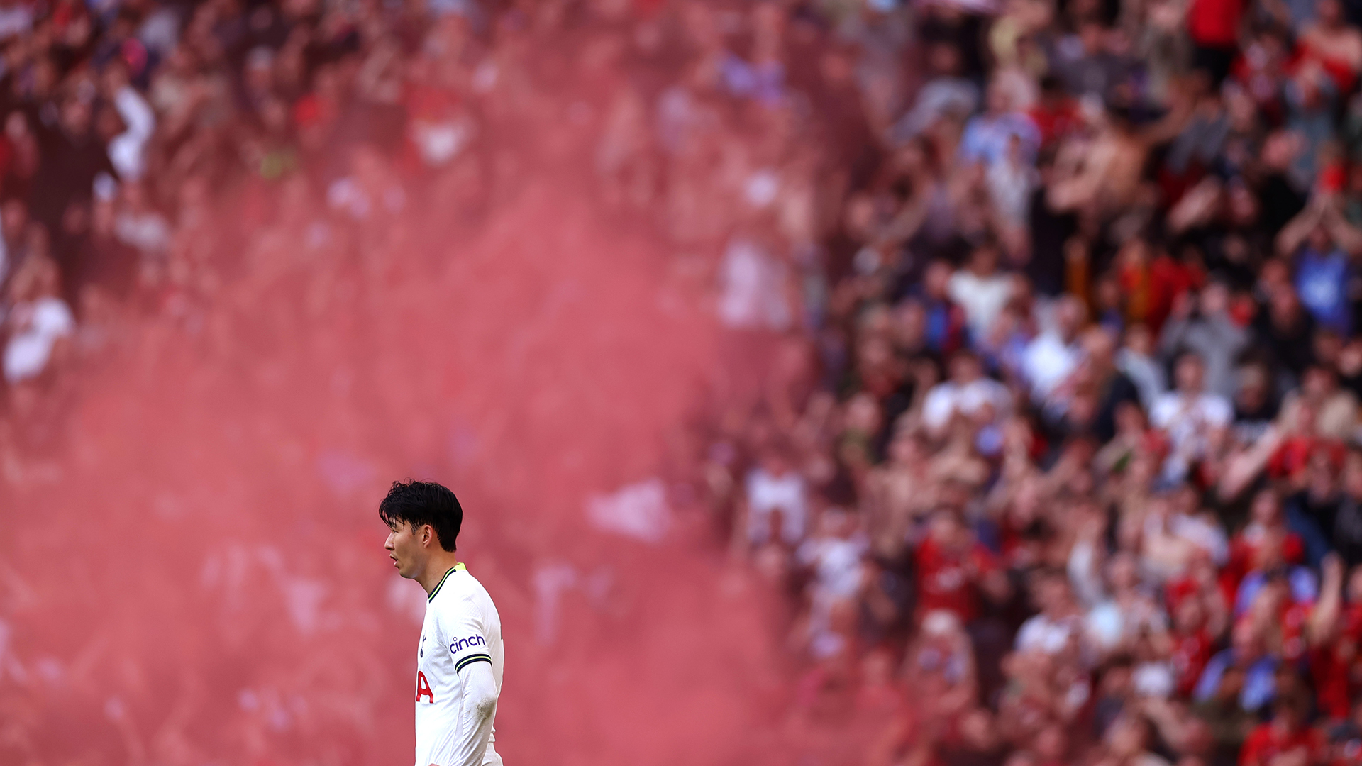 Son Heung-Min of Tottenham Hotspur looks on in-front of a flare after Bournemouth score their third goal during the Premier League match between Tottenham Hotspur and AFC Bournemouth at Tottenham Hotspur Stadium on April 15, 2023 in London, England.