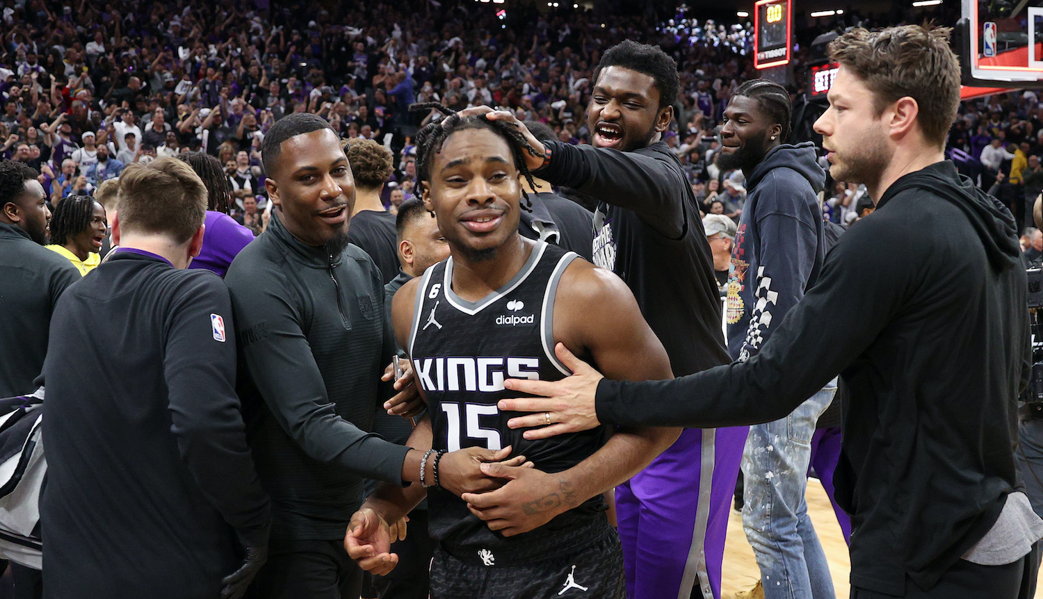 SACRAMENTO, CALIFORNIA - APRIL 17: Davion Mitchell #15 of the Sacramento Kings is congratulated by teammates after they beat the Golden State Warriors in Game Two of the Western Conference First Round Playoffs at Golden 1 Center on April 17, 2023 in Sacramento, California. NOTE TO USER: User expressly acknowledges and agrees that, by downloading and or using this photograph, User is consenting to the terms and conditions of the Getty Images License Agreement. (Photo by Ezra Shaw/Getty Images)