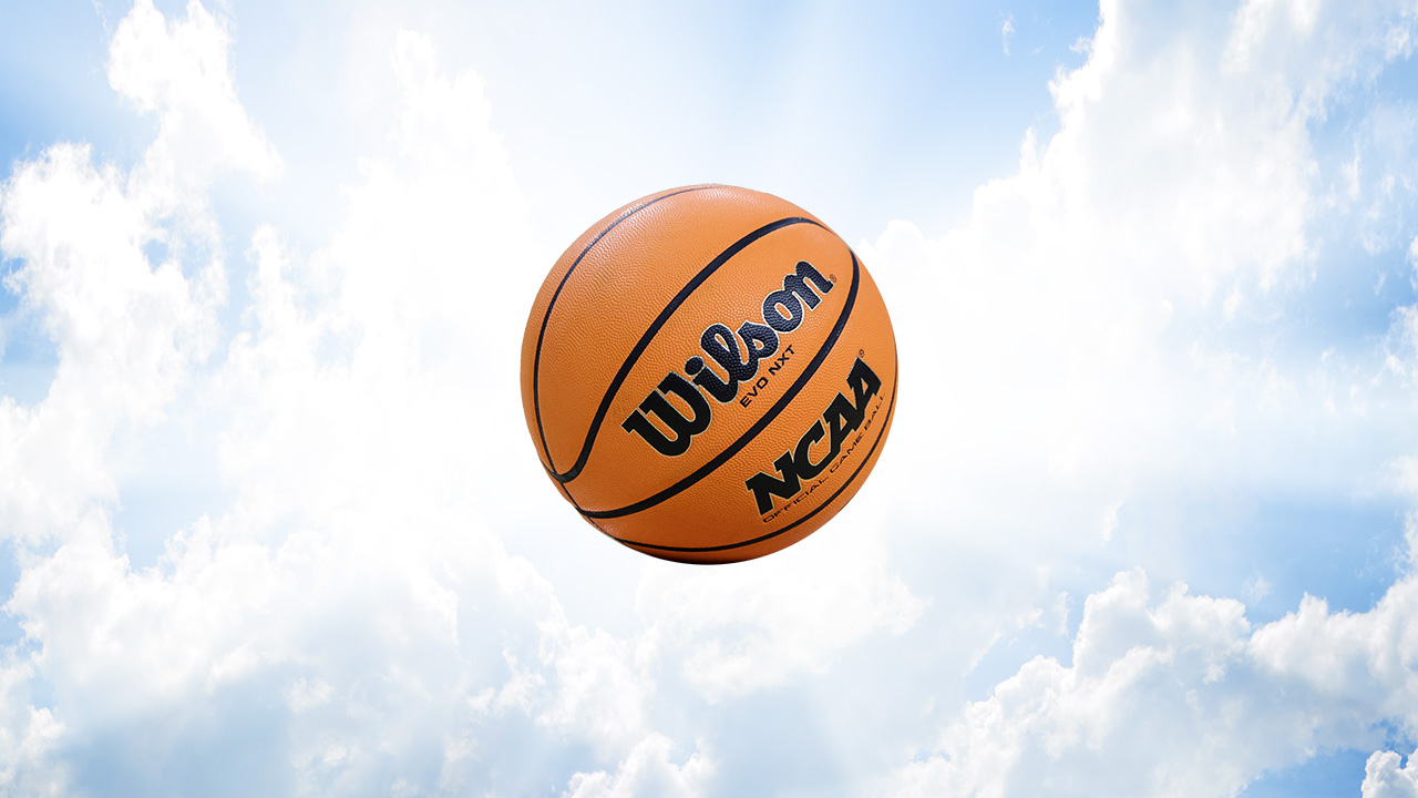 The sky with an angelic light behind it, the Wilson Evo NXT basketball sits in the middle