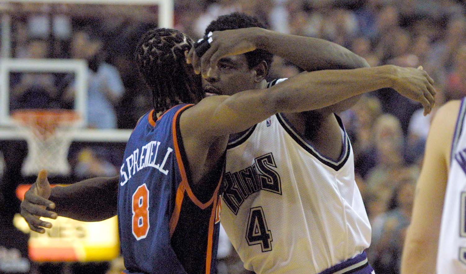 Chris Webber and Latrell Sprewell hug each other.