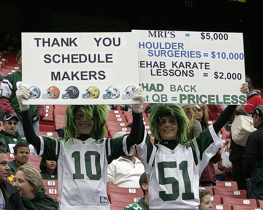Jets fan holding up a "Thank you schedule makers" sign at a game