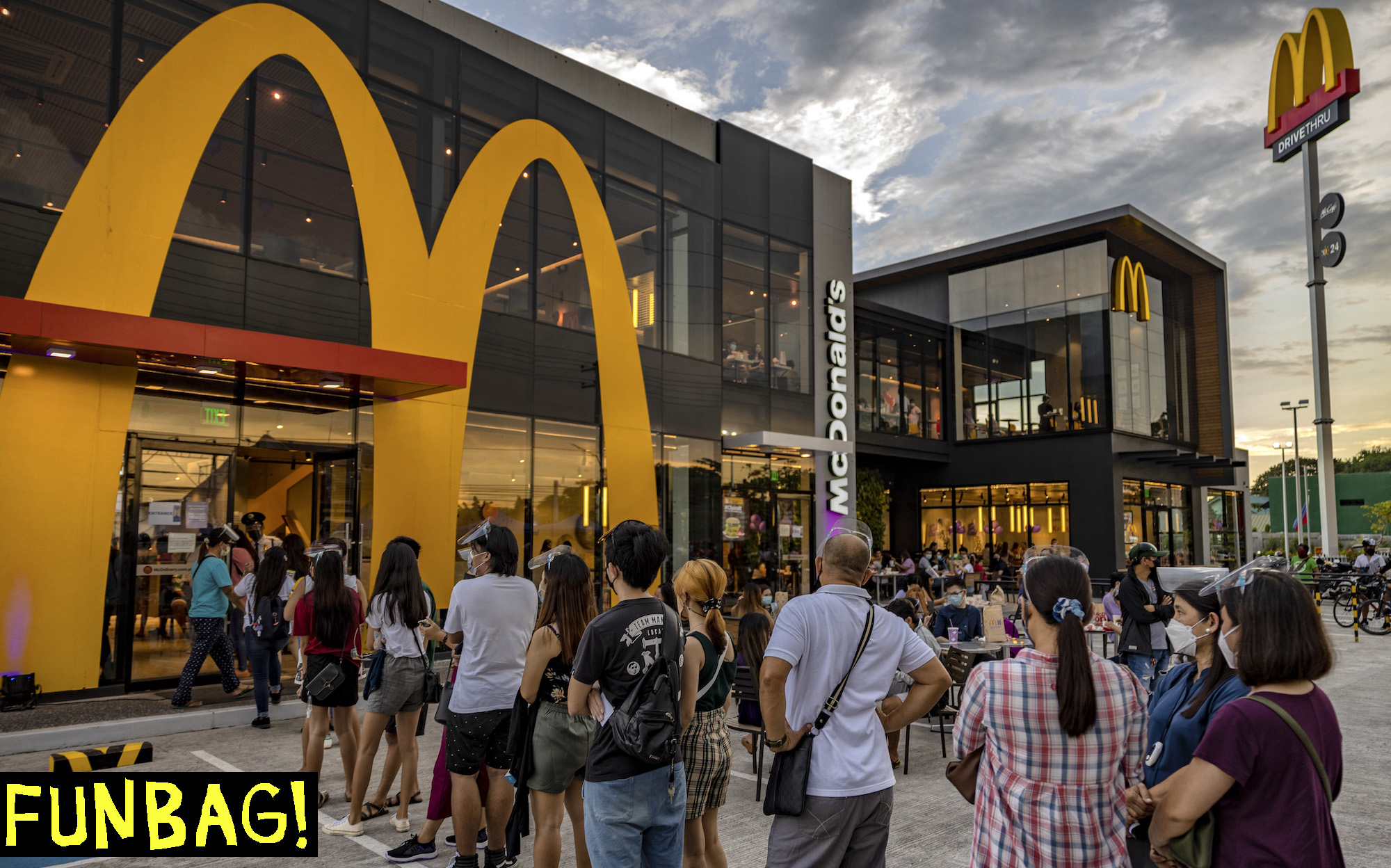 SAN FERNANDO, PHILIPPINES - JUNE 18: Customers queue at a McDonald's restaurant during the launch of the BTS Meal on June 18, 2021 in San Fernando, Pampanga province, Philippines. Long queues formed in several McDonald's restaurants in the Philippines as fans of the K-pop group BTS flocked to order the newly launched and wildly popular BTS themed meals. The limited edition celebrity meal "BTS Meal", a collaboration between the fastfood giant and BTS, will be made available in 49 countries. (Photo by Ezra Acayan/Getty Images)