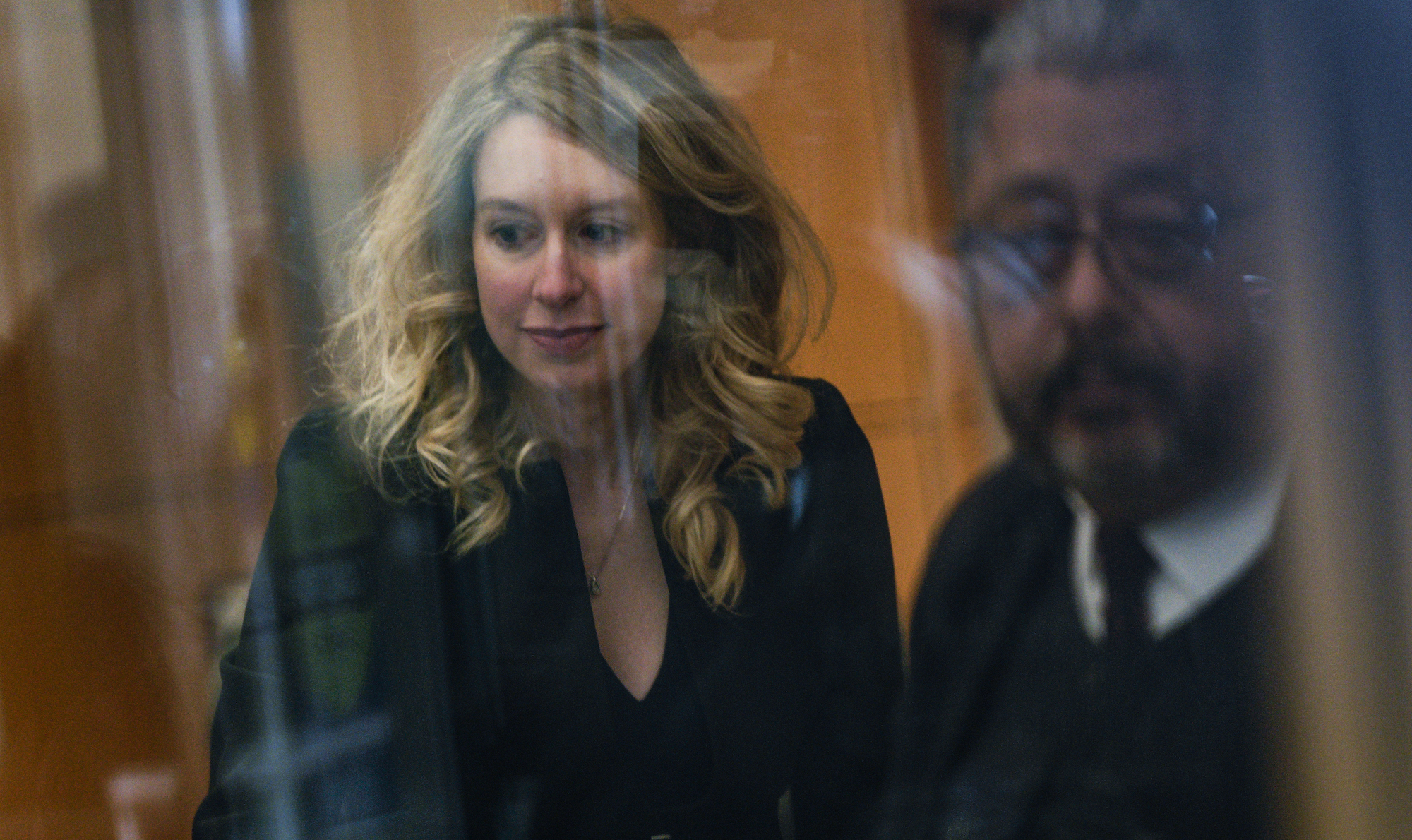 SAN JOSE, CA - MARCH 17: Former Theranos CEO Elizabeth Holmes moves through security while on her way to court on March 17, 2023 in San Jose, California. Holmes is appearing in court for a restitution hearing. (Photo by Philip Pacheco/Getty Images)