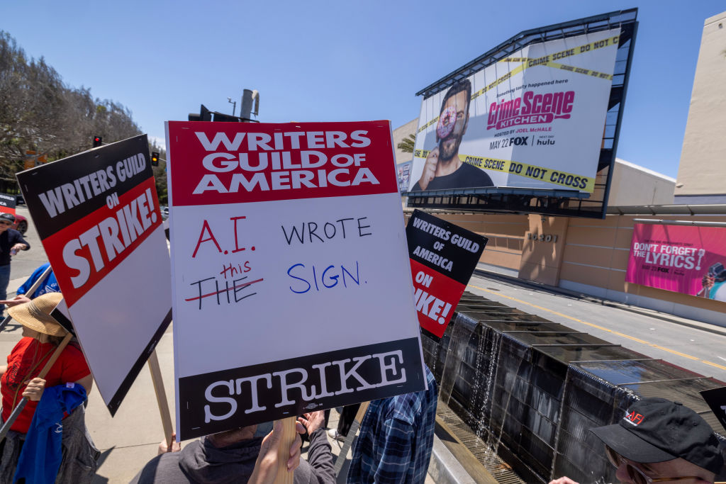 LOS ANGELES, CA - MAY 02: People picket outside of FOX Studios on the first day of the Hollywood writers strike on May 2, 2023 in Los Angeles. Scripted TV series, late-night talk shows, film and streaming productions are being interrupted by the Writers Guild of America (WGA) strike. In 2007 and 2008, a WGA strike shut down Hollywood productions for 100 days, costing the local economy between $2 billion and $3 billion.