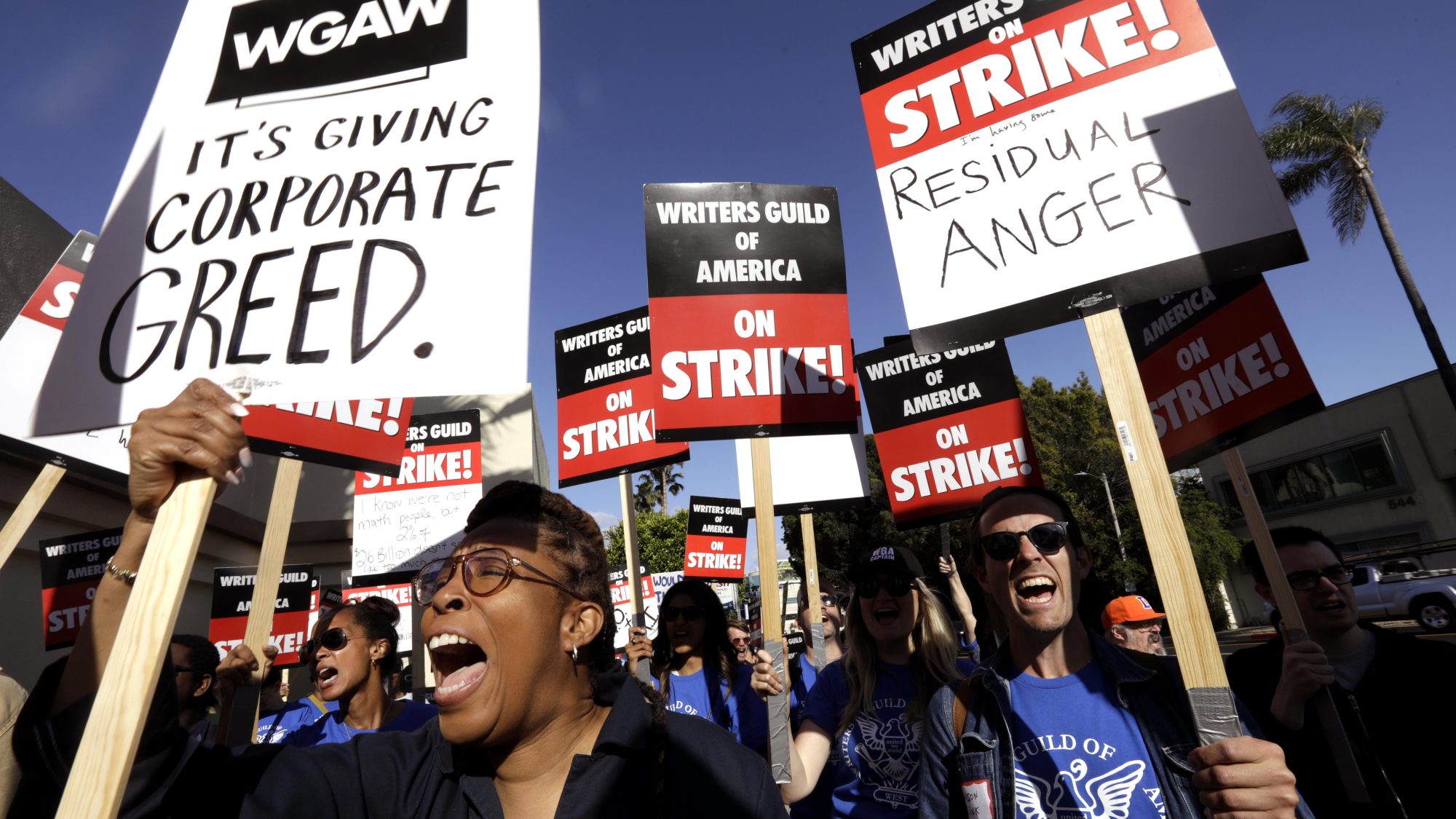 Actor and writer Daheli Hall, left, joins WGA members as they cheer on the first day of their strike in front of Paramount Studios in Hollywood on May 2, 2023.