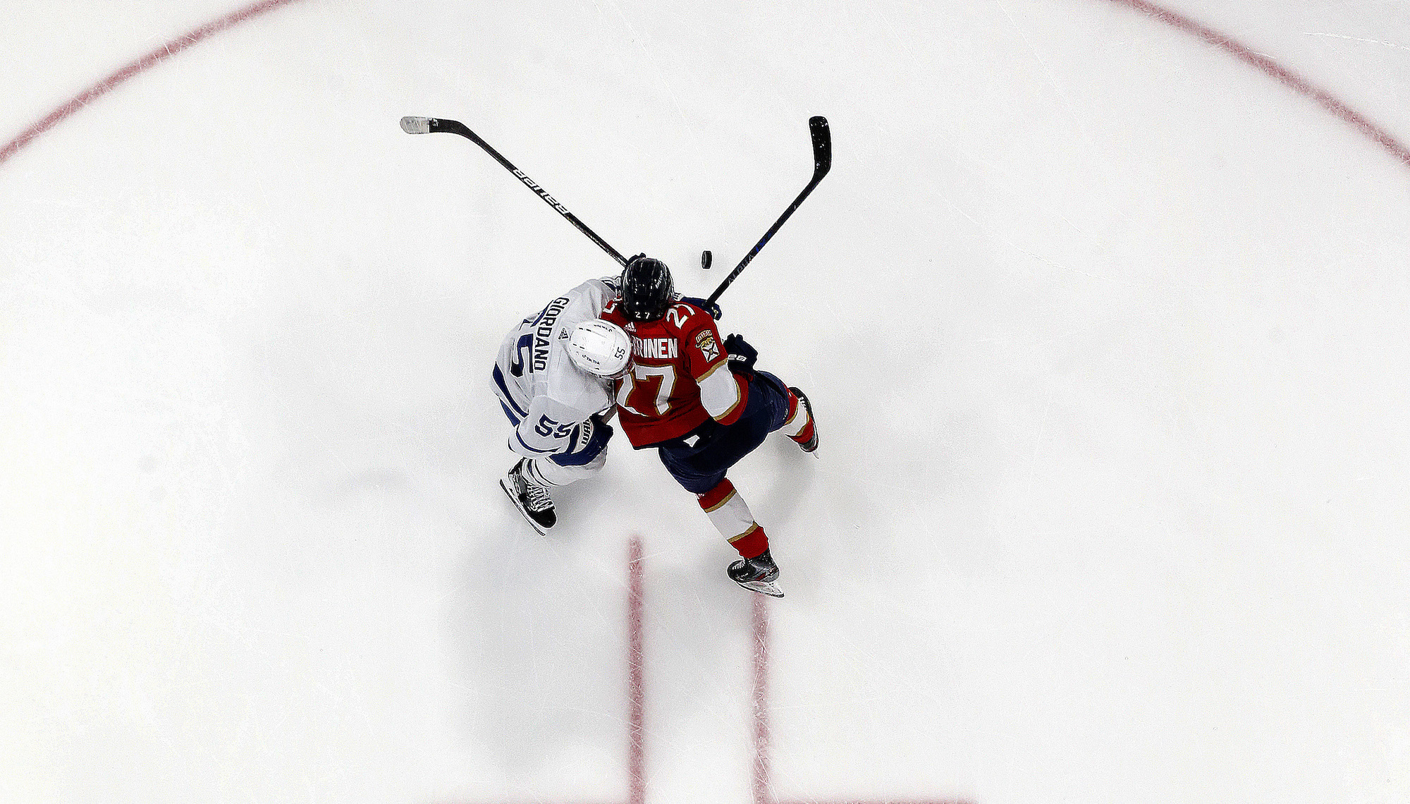 SUNRISE, FLORIDA - APRIL 10: Eetu Luostarinen #27 of the Florida Panthers tangles with Mark Giordano #55 of the Toronto Maple Leafs at the FLA Live Arena on April 10, 2023 in Sunrise, Florida. (Photo by Eliot J. Schechter/NHLI via Getty Images)