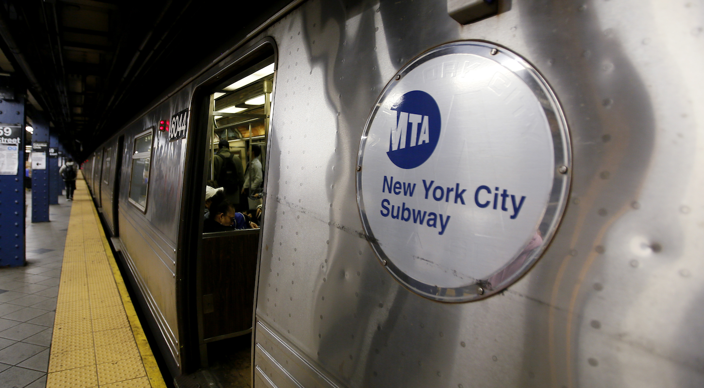 An NYC subway car with an MTA badge by the door