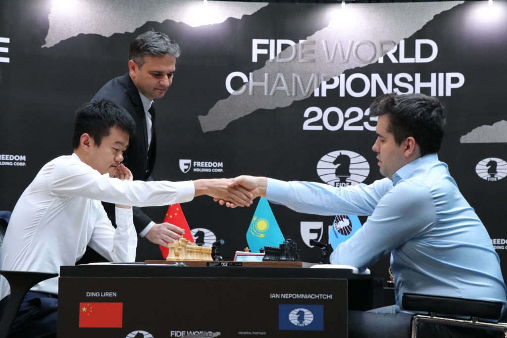 ASTANA, KAZAKHSTAN - APRIL 29: Grandmaster Ding Liren (L) of China shakes hands with grandmaster Ian Nepomniachtchi of Russia during the 2023 World Chess Championship at the St Regis Astana Hotel on April 29, 2023 in Astana, Kazakhstan. (