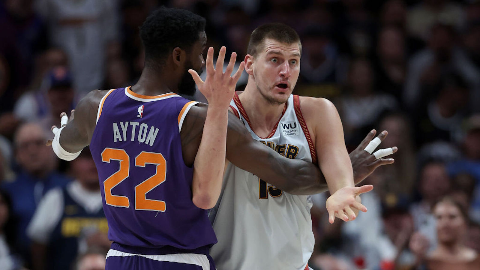 DENVER, COLORADO - MAY 09: Nikola Jokic #15 of the Denver Nuggets looks for a call while being guarded by Deandre Ayton #22 of the Phoenix Suns in the third quarter during Game Five of the NBA Western Conference Semifinals at Ball Arena on May 09, 2023 in Denver, Colorado. NOTE TO USER: User expressly acknowledges and agrees that, by downloading and/or using this photograph, User is consenting to the terms and conditions of the Getty Images License Agreement.