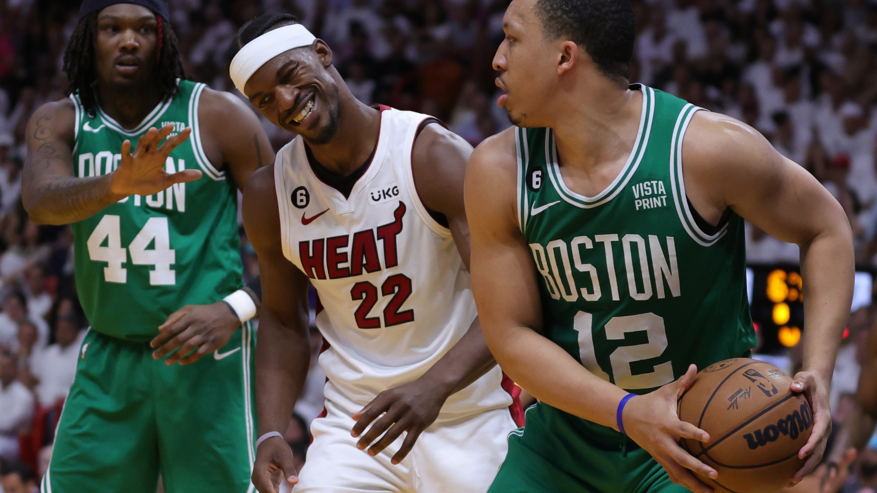 MIAMI, FLORIDA - MAY 23: Grant Williams #12 of the Boston Celtics controls the ball ahead of Jimmy Butler #22 of the Miami Heat during the fourth quarter in game four of the Eastern Conference Finals at Kaseya Center on May 23, 2023 in Miami, Florida. NOTE TO USER: User expressly acknowledges and agrees that, by downloading and or using this photograph, User is consenting to the terms and conditions of the Getty Images License Agreement. (Photo by Megan Briggs/Getty Images)