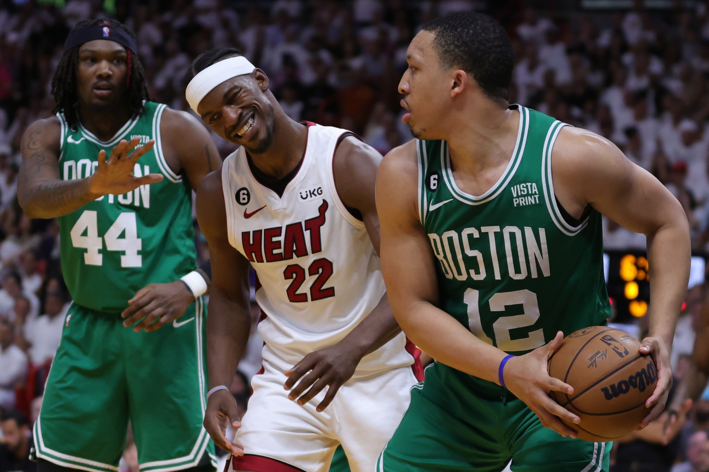 MIAMI, FLORIDA - MAY 23: Grant Williams #12 of the Boston Celtics controls the ball ahead of Jimmy Butler #22 of the Miami Heat during the fourth quarter in game four of the Eastern Conference Finals at Kaseya Center on May 23, 2023 in Miami, Florida. NOTE TO USER: User expressly acknowledges and agrees that, by downloading and or using this photograph, User is consenting to the terms and conditions of the Getty Images License Agreement. (Photo by Megan Briggs/Getty Images)