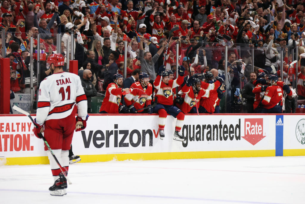 The Panthers celebrate while Jordan Staal looks on