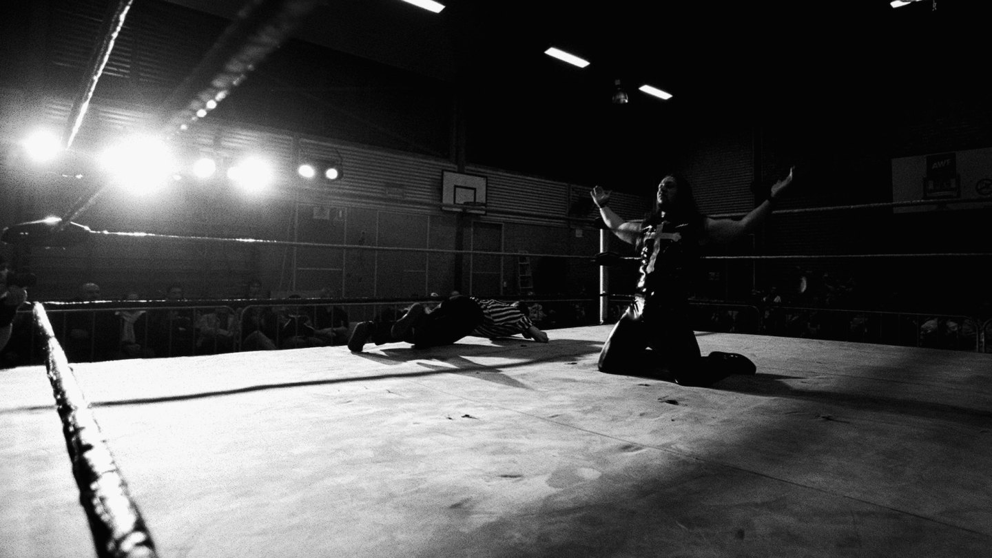 SYDNEY, AUSTRALIA - JUNE 04: Wrestler TNT celebrates his victory as the referee gets out of the way during the AWF "Thomas Reddall Rumble" held in the Gymnasium at Thomas Reddall High School June 4, 2004 in Sydney, Australia. For this group of die-hard sports professionals who spend most Saturdays training and wrestling in a small dojo in Sydney's South West. It's a ritual that goes way beyond dedication reaching into the realm of obsession. Founded in 1999, the AWF has now grown to over fifty professional wrestlers Australia wide. Hosting regular bout nights across the country, means these guys get a chance to do things they don't normally get to do, the blood is real and injuries happen, often. After starting a school for wrestling six years ago, AWF founder Greg Bowden has trained more than fifty pro wrestlers, in a bid to help promote the sport and build a substantial fan base. Unlike America's WWE group, which is broadcast regularly around the world via cable television, the AWF, despite numerous attempts, have been unable to secure television broadcast support, which constantly hampers the sport's promotion, keeping crowd numbers down and the group confined to low cost venues and shows. (Photo by Chris McGrath/Getty Images)