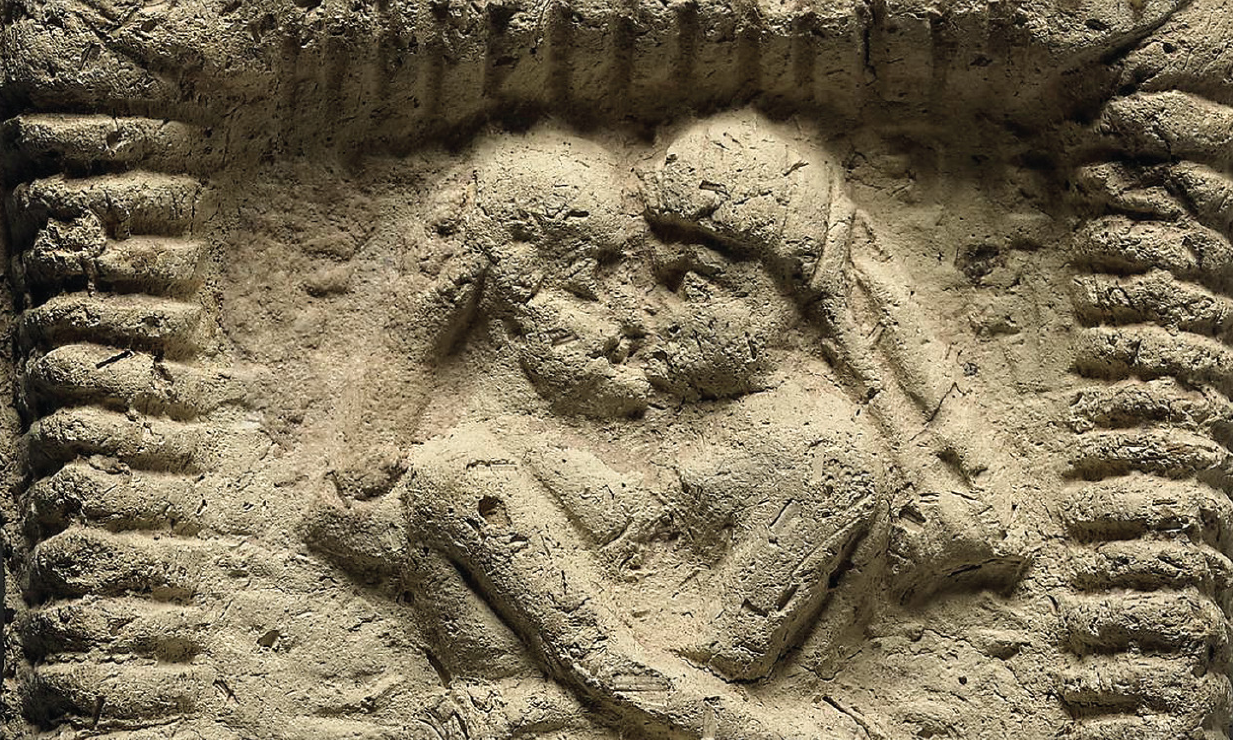 A close-up of a clay model from Mesopotamia that dates back to 1800 BCE, depicting a nude couple kissing and copulating.