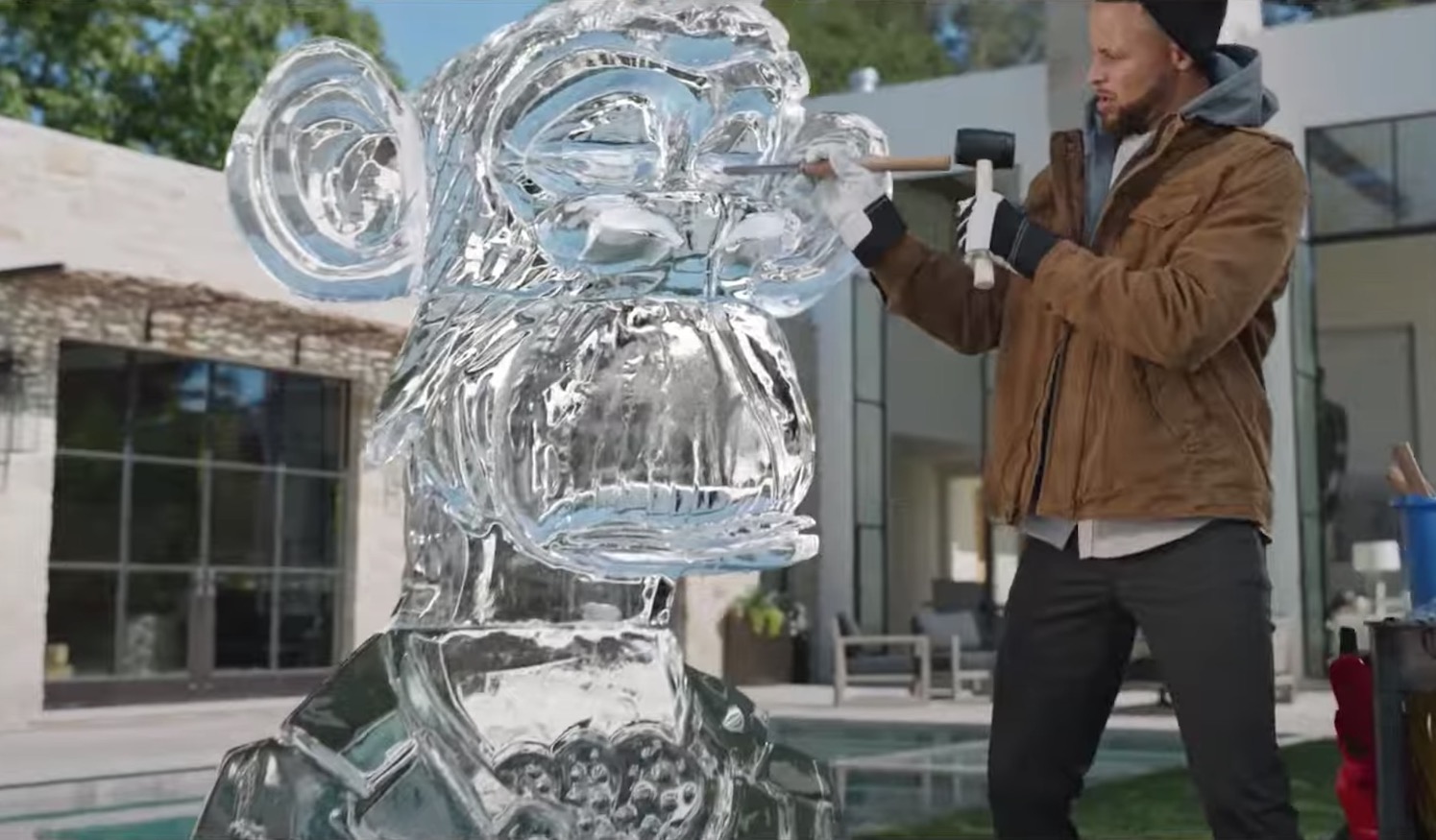 Steph Curry carves a Bored Ape ice sculpture.