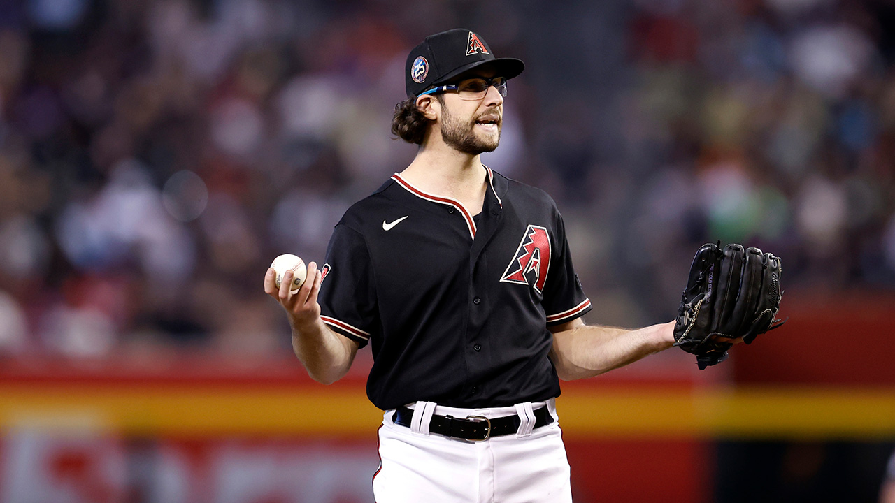 PHOENIX, ARIZONA - MAY 13: Starting pitcher Zac Gallen #23 of the Arizona Diamondbacks gestures at home plate umpire Ramon De Jesus #18 during the fourth inning against the San Francisco Giants at Chase Field on May 13, 2023 in Phoenix, Arizona.