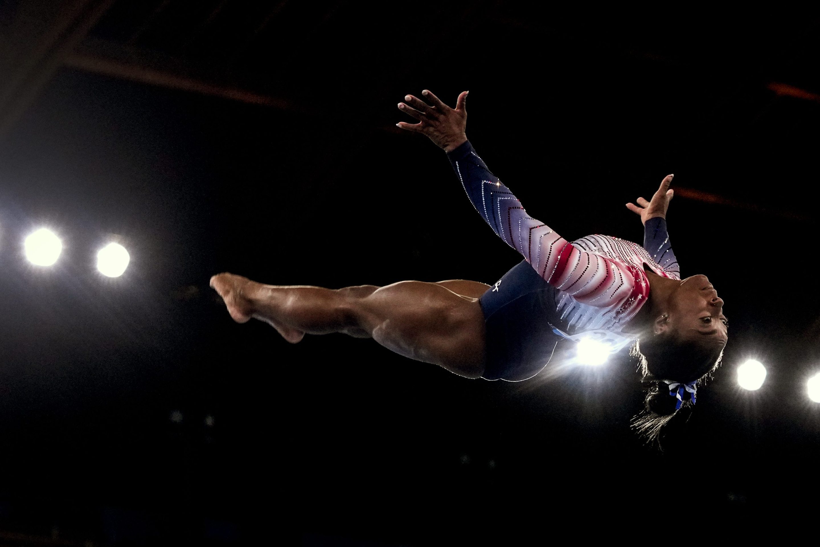 Gymnast Simone Biles of Team United States flips through the air as performs her dismount during the Tokyo 2020 Olympic Games Women's Gymnastics Balance Beam Final at Ariake Gymnastics Center on Tuesday, August 3, 2021