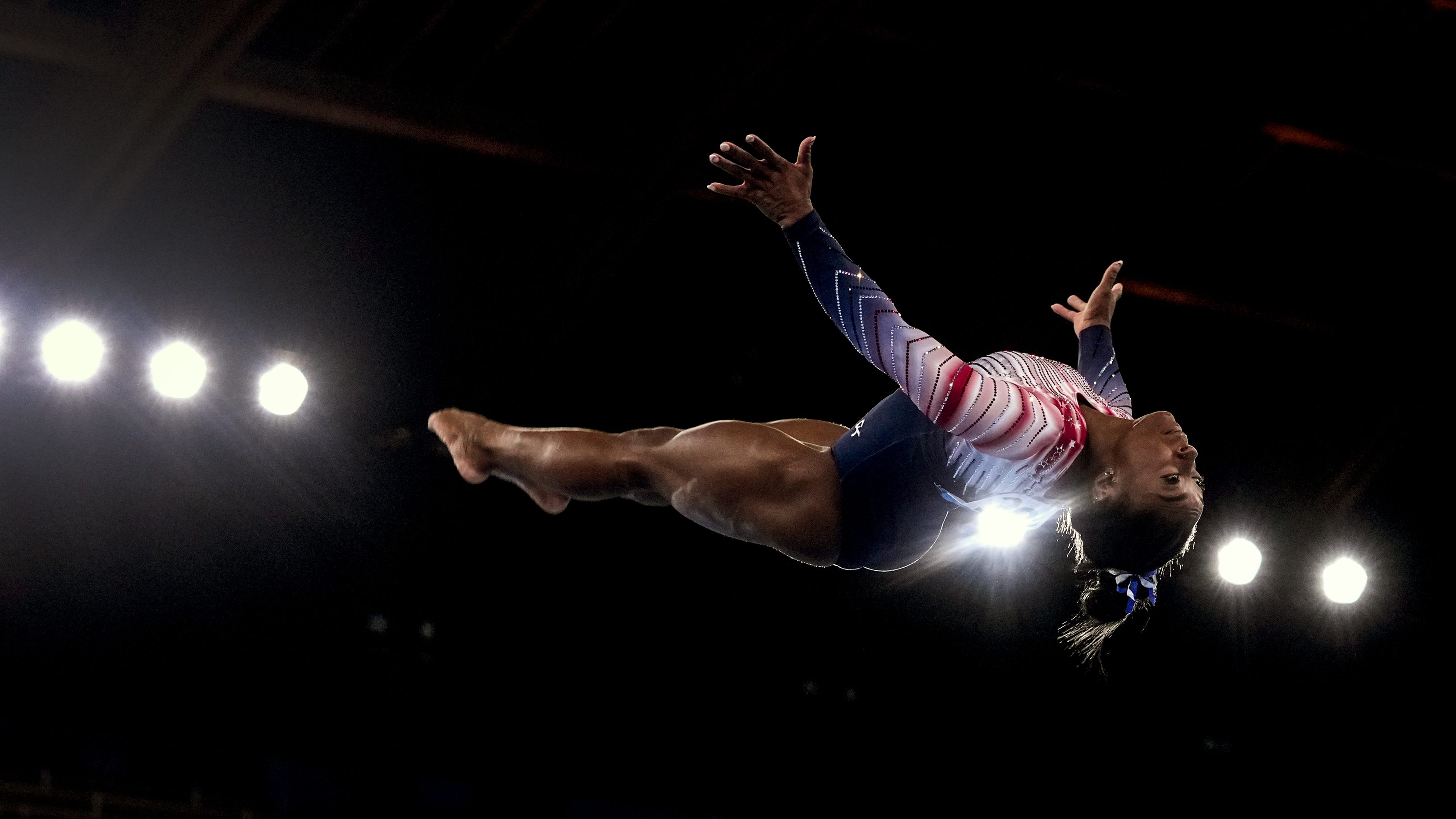 Gymnast Simone Biles of Team United States flips through the air as performs her dismount during the Tokyo 2020 Olympic Games Women's Gymnastics Balance Beam Final at Ariake Gymnastics Center on Tuesday, August 3, 2021