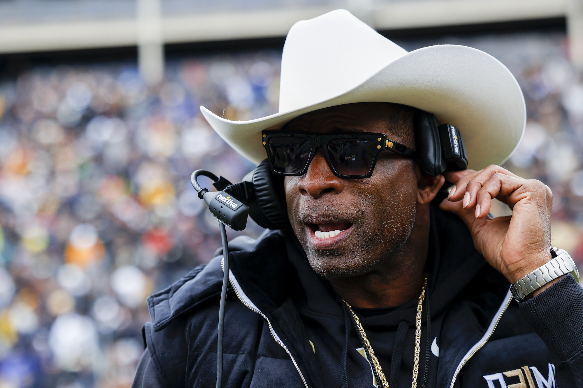 BOULDER, UNITED STATES - APRIL 22: University of Colorado football head coach Deion Sanders secures his headset under his cowboy hat during the Spring football game as part of Black and Gold Day on April 22, 2023. (Photo by Michael Ciaglo for The Washington Post)