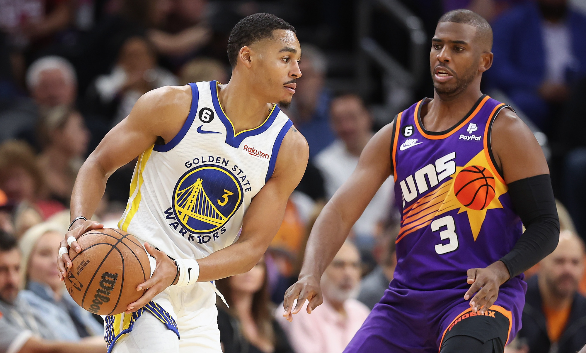 PHOENIX, ARIZONA - OCTOBER 25: Jordan Poole #3 of the Golden State Warriors handles the ball against Chris Paul #3 of the Phoenix Suns during the second half of the NBA game at Footprint Center on October 25, 2022 in Phoenix, Arizona. The Suns defeated the Warriors 134-105. NOTE TO USER: User expressly acknowledges and agrees that, by downloading and or using this photograph, User is consenting to the terms and conditions of the Getty Images License Agreement. (Photo by Christian Petersen/Getty Images)