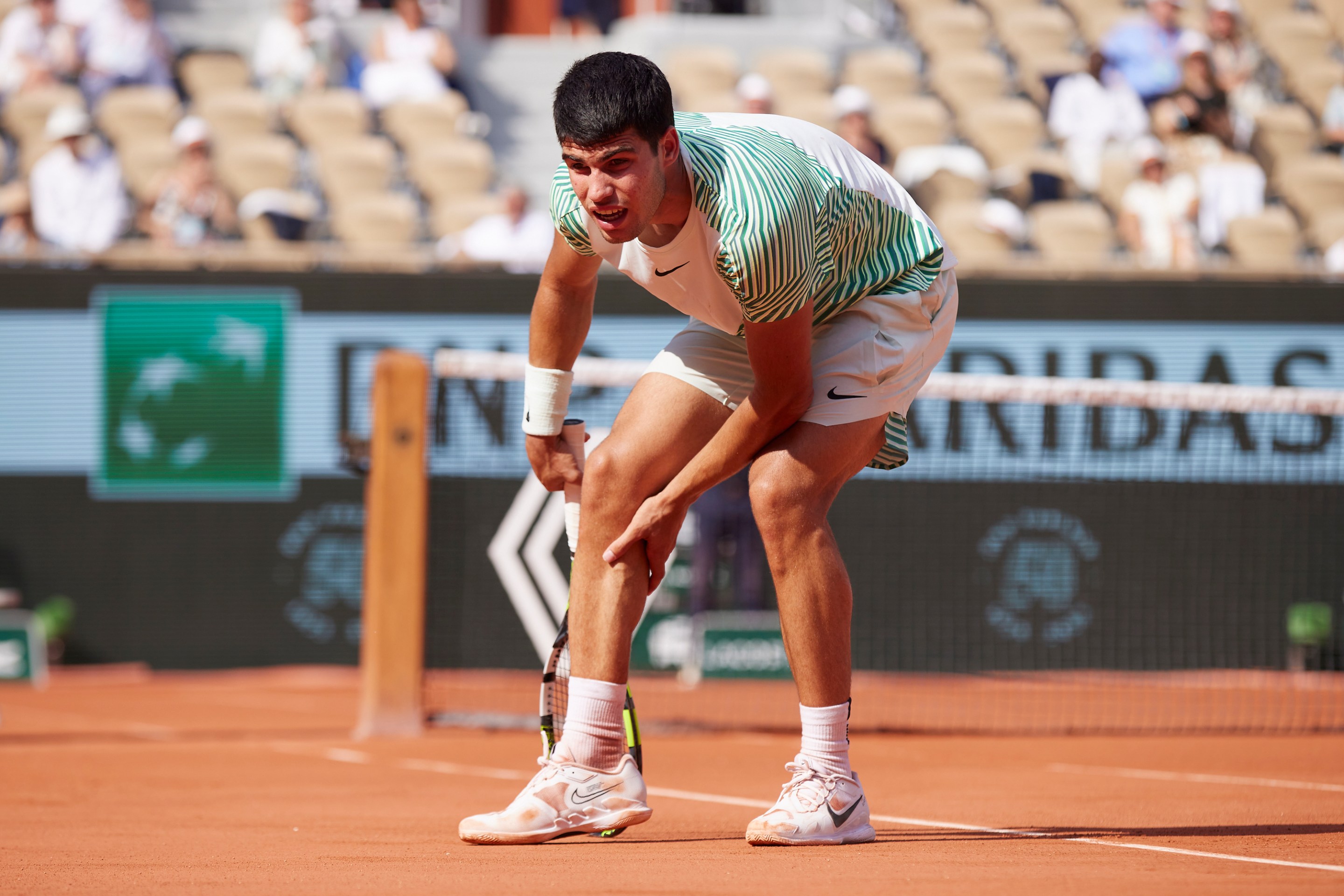 PARIS, FRANCE - JUNE 09: Carlos Alcaraz of Spain appears to be injured against Novak Djokovic of Serbia during the Men's Singles Semi Final match on Day Thirteen of the 2023 French Open at Roland Garros on June 09, 2023 in Paris, France.