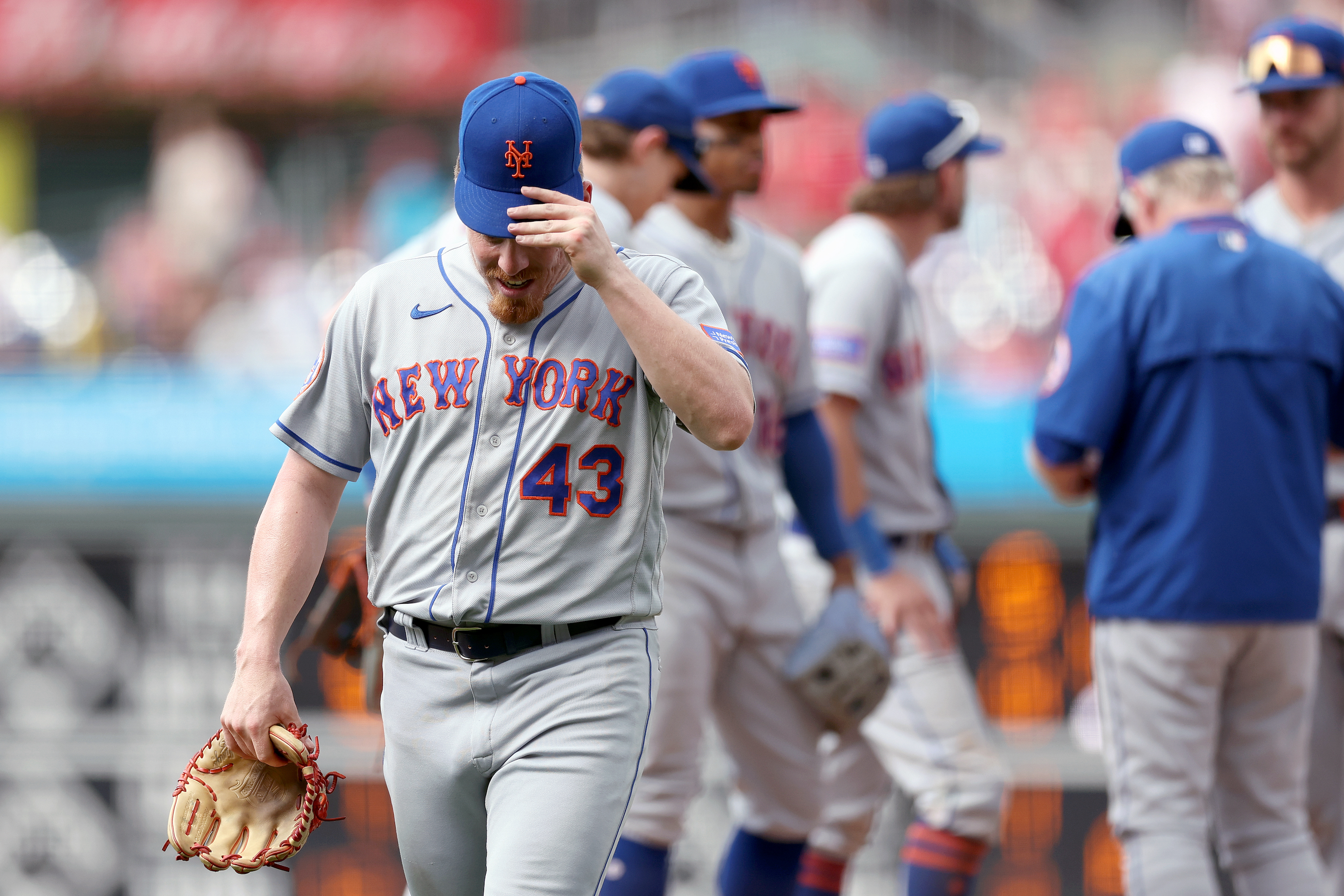 Reliever Jeff Brigham leaves the mound after hitting two straight batters to plate the winning run in a Mets loss against the Phillies.