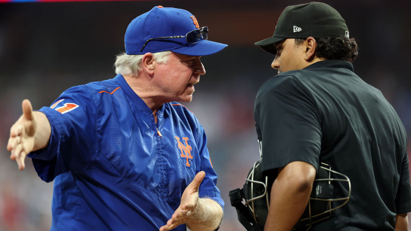 PHILADELPHIA, PENNSYLVANIA - JUNE 25: Buck Showalter #11 of the New York Mets and umpire Erich Bacchus #12 speak during the ninth inning of a game between the Philadelphia Phillies and the New York Mets at Citizens Bank Park on June 25, 2023 in Philadelphia, Pennsylvania.