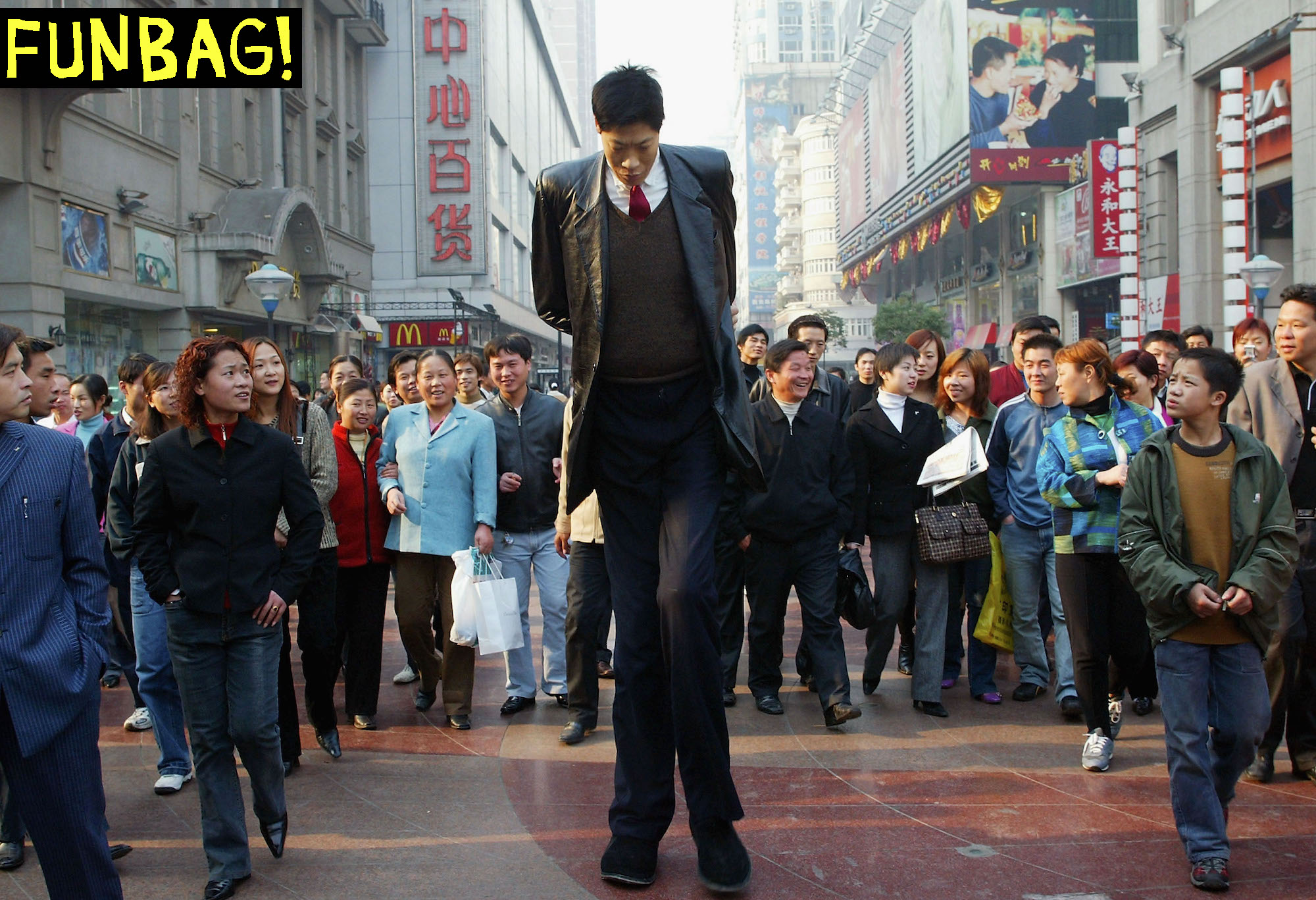 WUHAN, CHINA - NOVEMBER 23: (CHINA OUT) Zhang Juncai, one of China's tallest men, who measures 2.42 metres in height, walks through the streets on November 23, 2004 in Wuhan, China. Zhang, from Shanxi province, is in Wuhan to seek treatment for his overweight problem. (Photo by China Pix/Getty Images) *** Local Caption *** Zhang Juncai