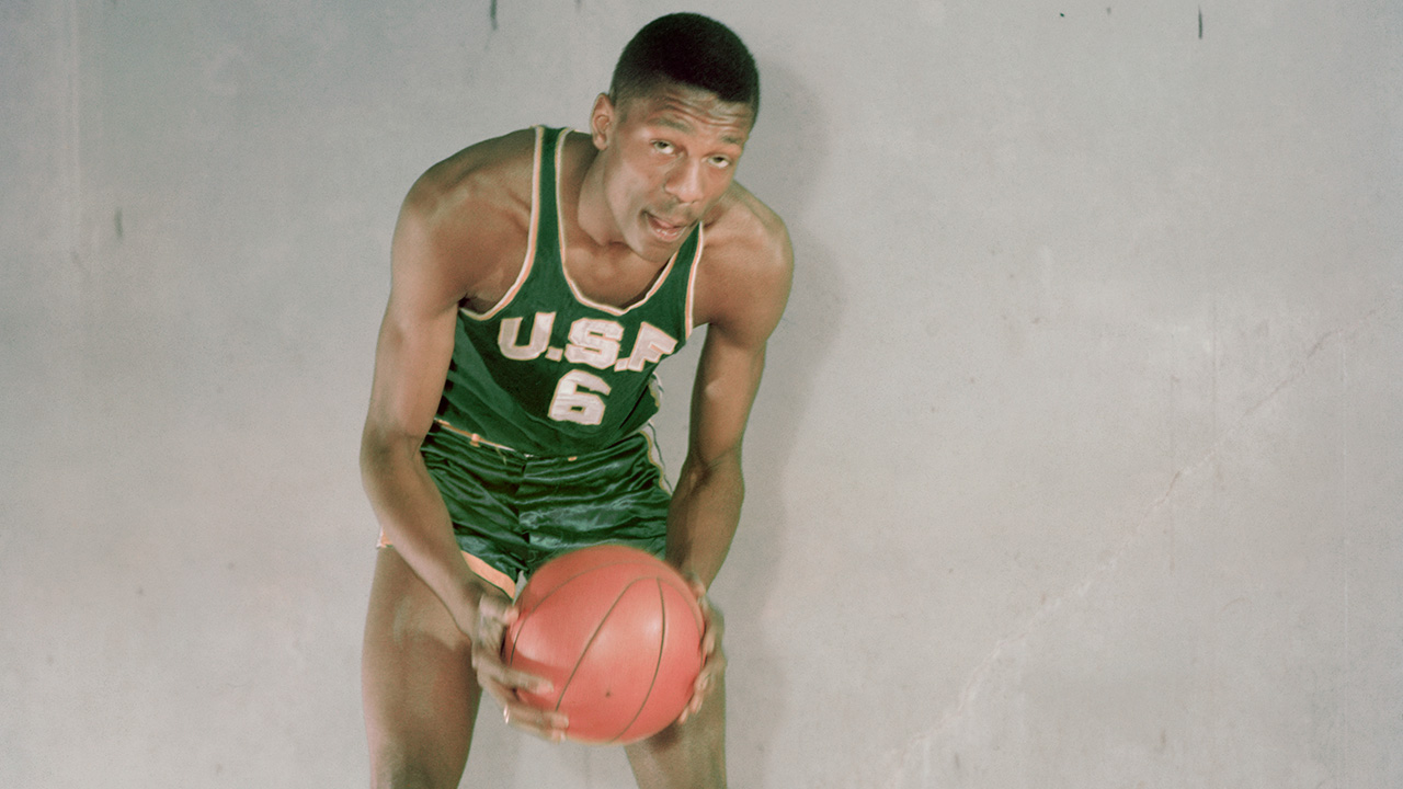 Bill Russell in a USF jersey holding a basketball. He's number 6.