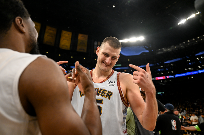 Nikola Jokic celebrates the Western Conference title with a teammate