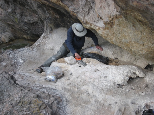 a researcher sawing a hole in a poop donut