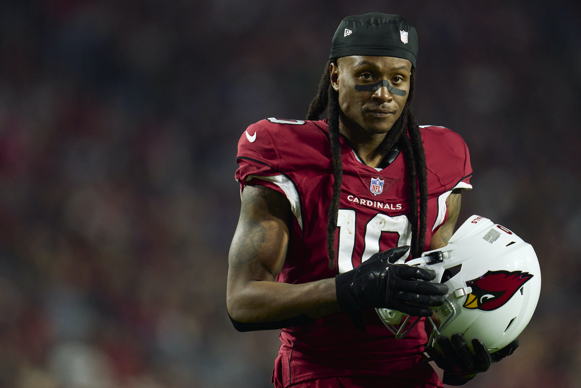 DeAndre Hopkins holds his helmet during a game between the Patriots and Cardinals.