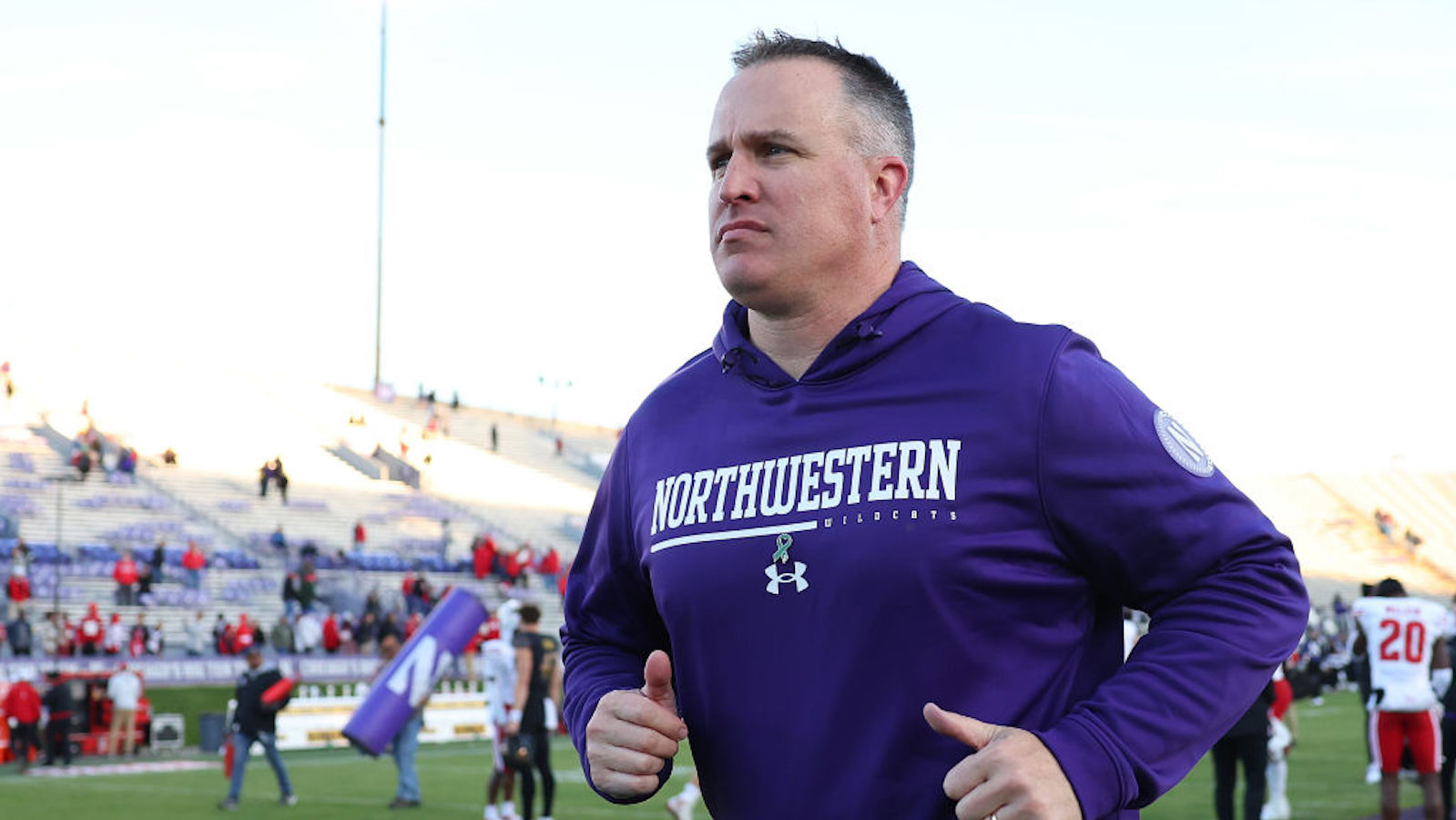 Head coach Pat Fitzgerald of the Northwestern Wildcats runs off the field after losing to the Wisconsin Badgers at Ryan Field on October 08, 2022 in Evanston, Illinois.